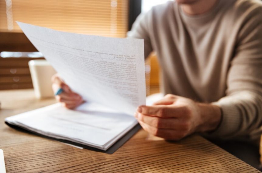 a man who is reading an offer letter